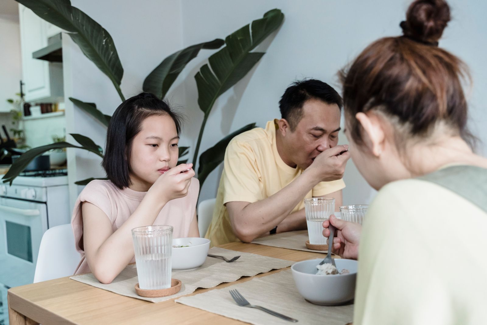 An Asian family gathered around the breakfast table at home